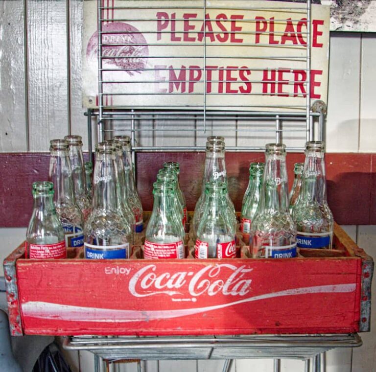 “Vintage soda bottles representing the Coca-Cola invention story and its origins in the 1880s.”