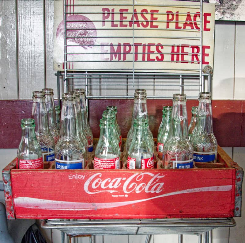 “Vintage soda bottles representing the Coca-Cola invention story and its origins in the 1880s.”