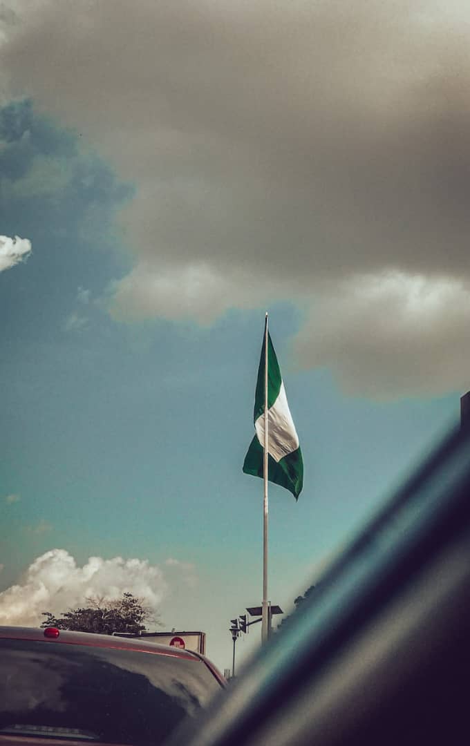 NIGERIAN flag beside financial document symbolizing national tax reforms in 2026